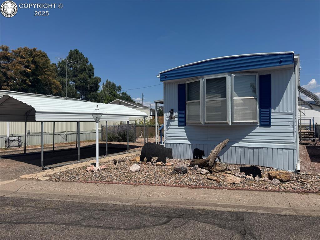 Caption: View of front of home with a carport