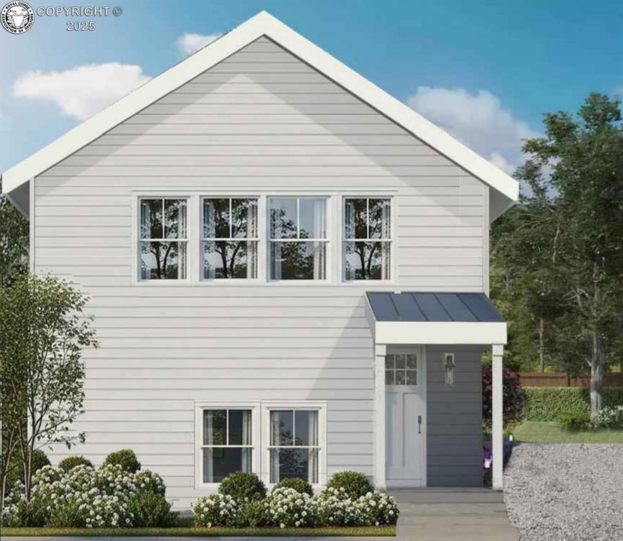 Caption: View of front of house featuring a standing seam roof and a metal roof