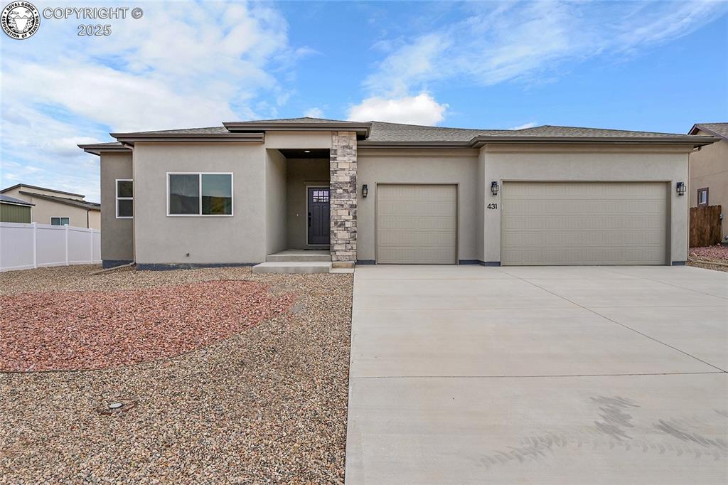 Caption: Prairie-style house featuring stucco siding, an attached garage, and concrete driveway