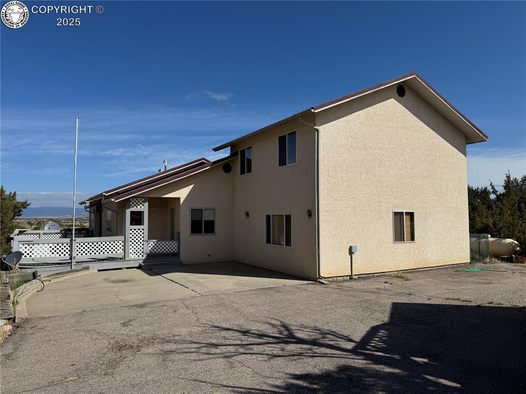 Caption: View of side of property featuring a patio area and stucco siding