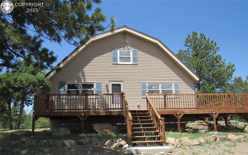 Caption: Front of home with large deck to enjoy your morning coffee