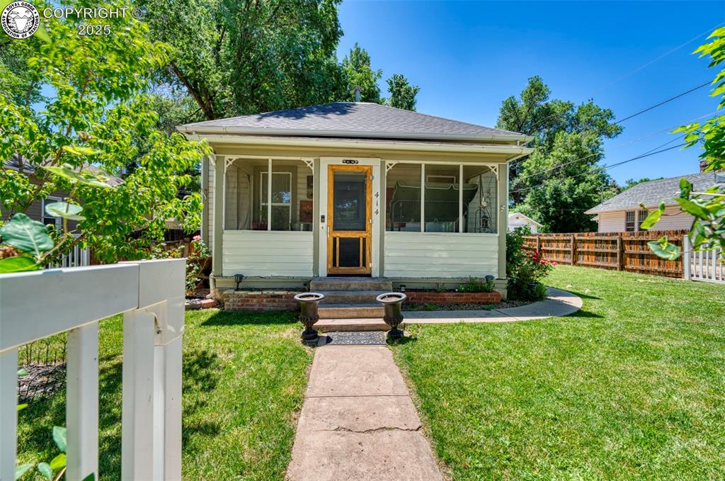 Caption: Bungalow-style house with roof with shingles and a sunroom