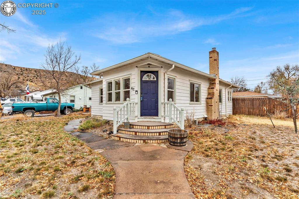 Caption: View of front of property featuring a chimney