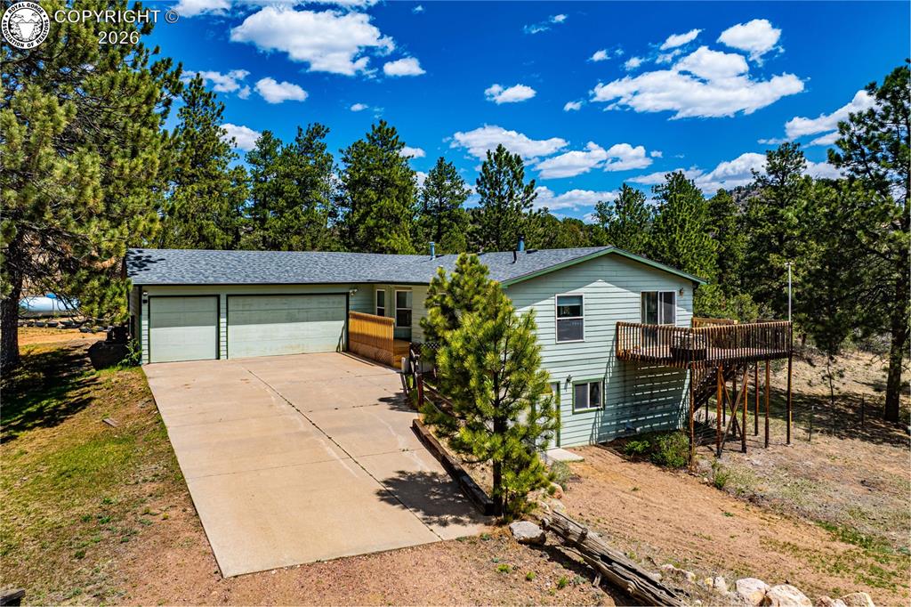Caption: Ranch-style residence featuring light green siding and a two-car garage
