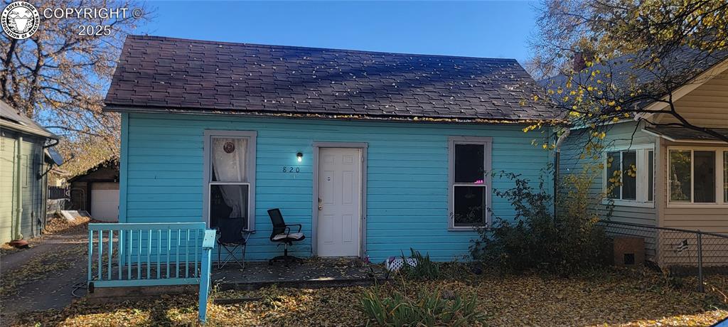 Caption: View of front of home with roof with shingles