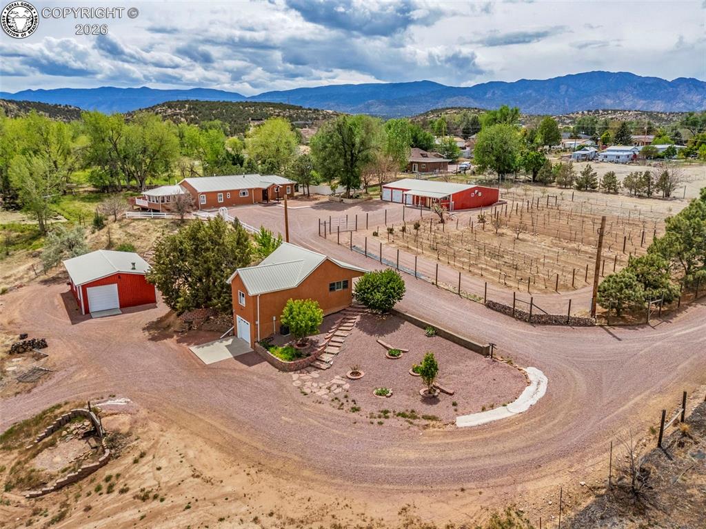 Caption: Nearly 5 acres or irrigated land with main house, cottage and two outbuildings.