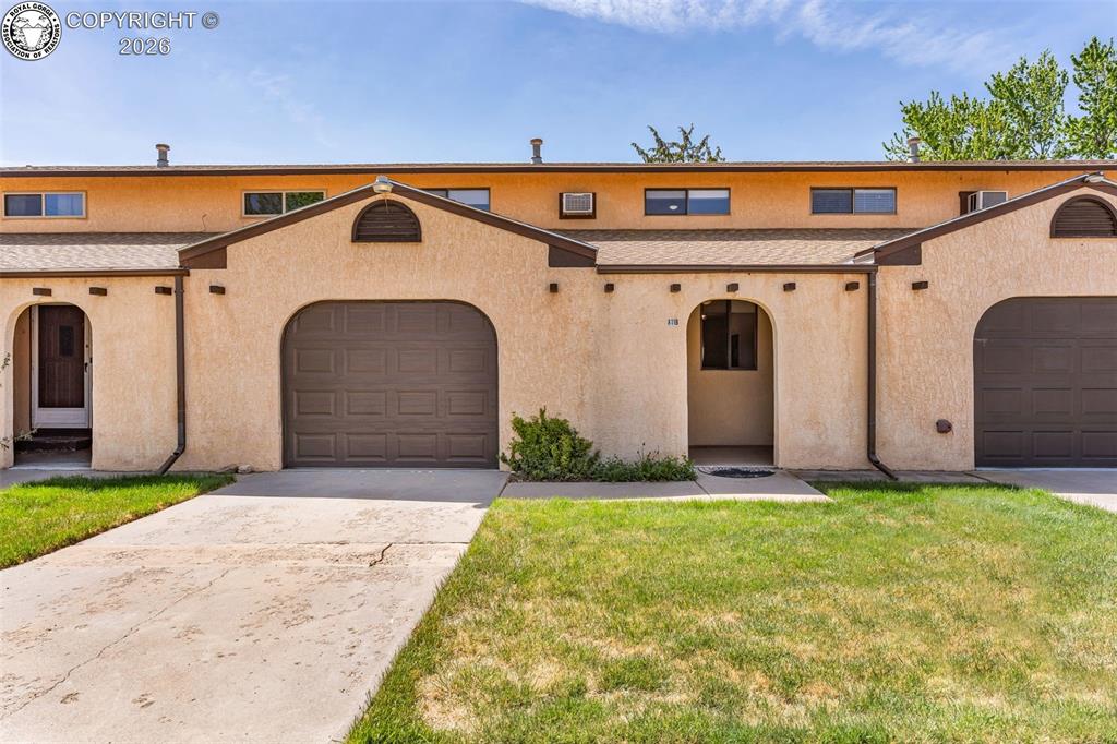 Caption: Lovely stucco condo with its own attached single car garage with interior entry.