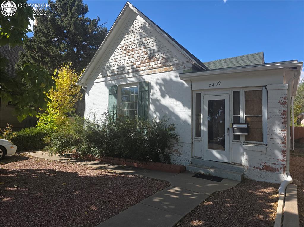 Caption: View of front of house featuring brick siding