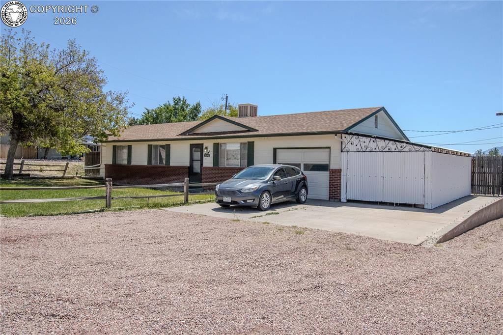 Caption: Single-story residence featuring a two-tone exterior with white siding and a brick skirting
