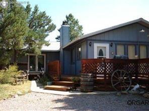 Caption: Rear view of property featuring a chimney