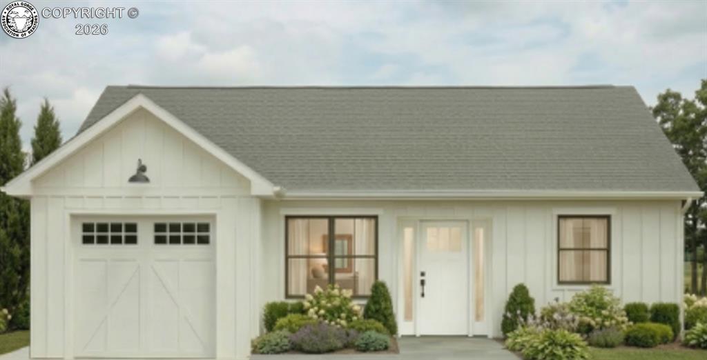 Caption: View of front facade featuring board and batten siding, a garage, and roof with shingles