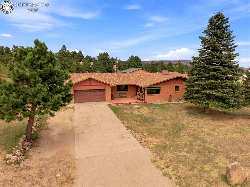 Caption: Brick exterior with an attached garage and concrete driveway