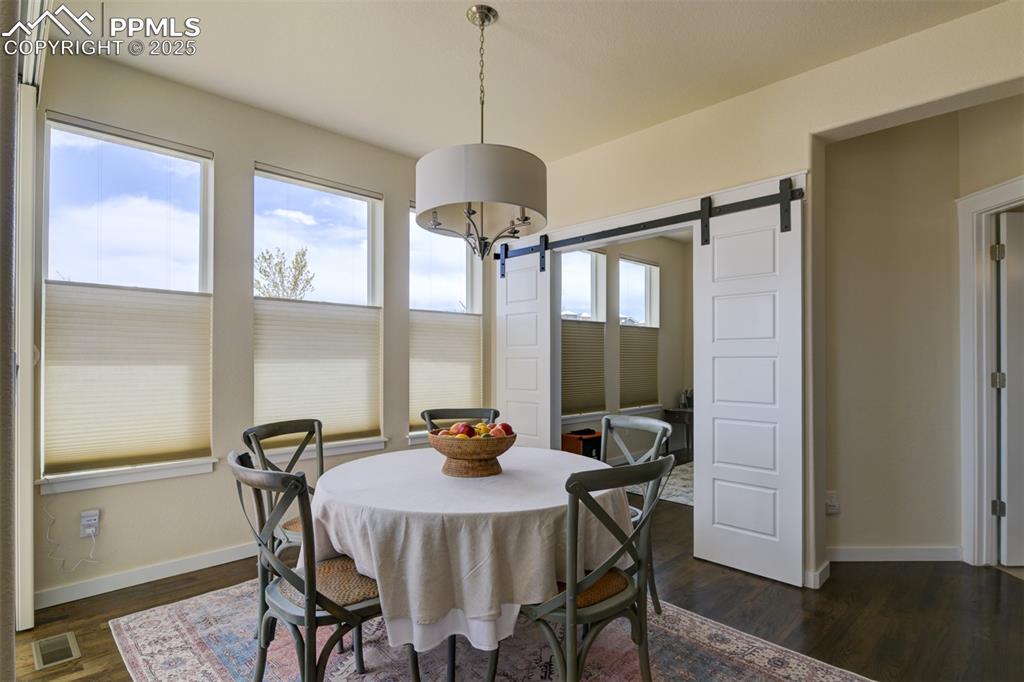 Image 18 of 45: Breakfast nook, charming sliding doors enter an office or main level bedroo