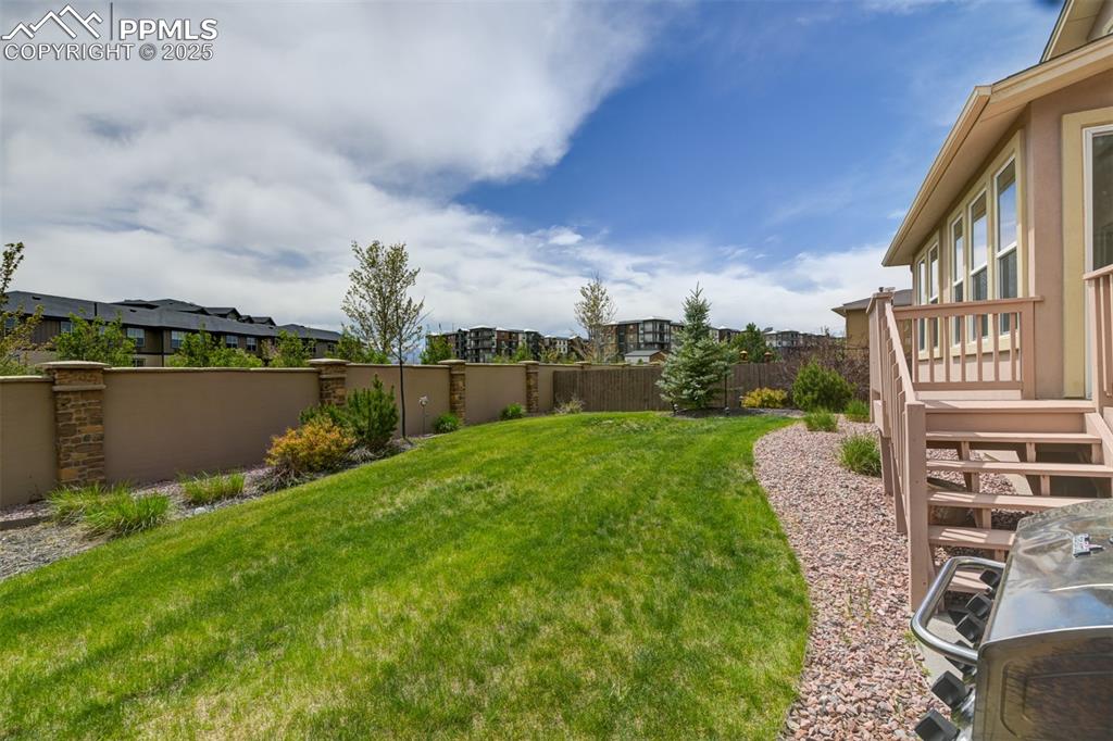 Image 39 of 45: Level lush fenced backyard