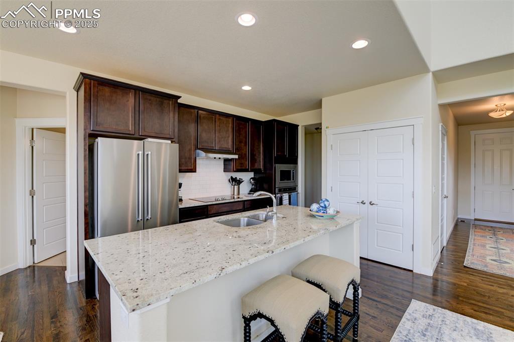 Image 9 of 45: Hardworking kitchen features SS appliances, granite countertops, pantry, is