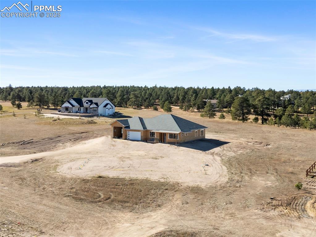 Image 5 of 6: Overview of rural landscape featuring a forest