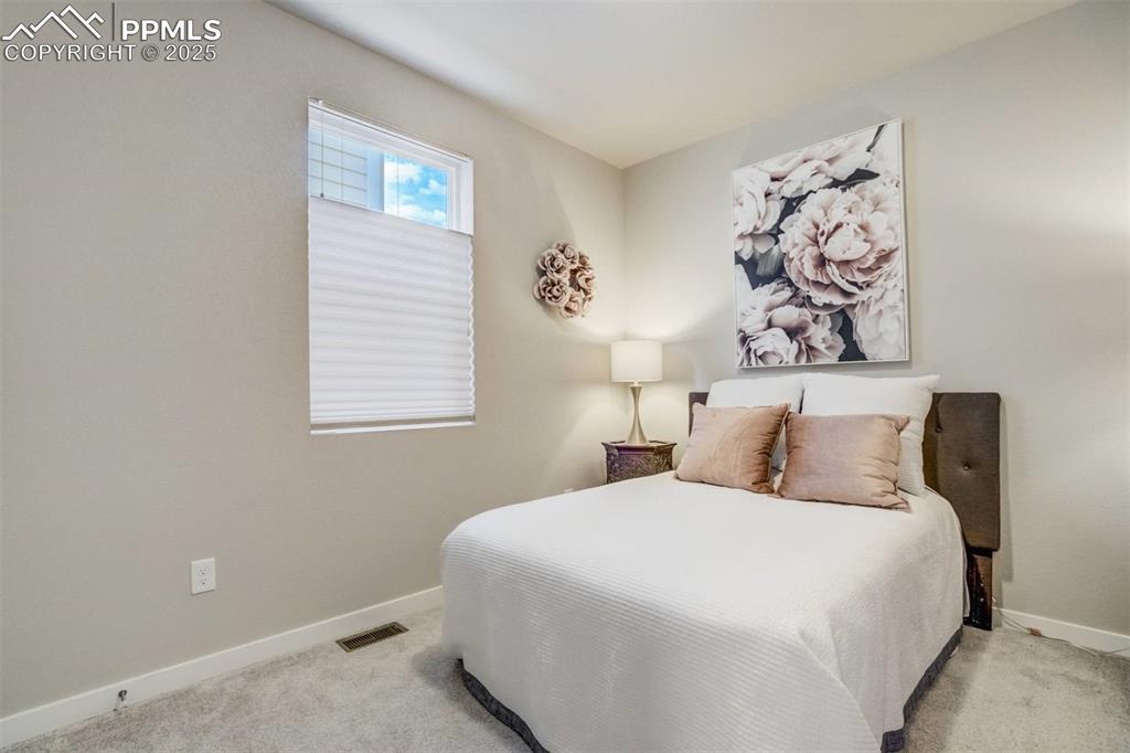 Image 15 of 44: Main level bedroom 