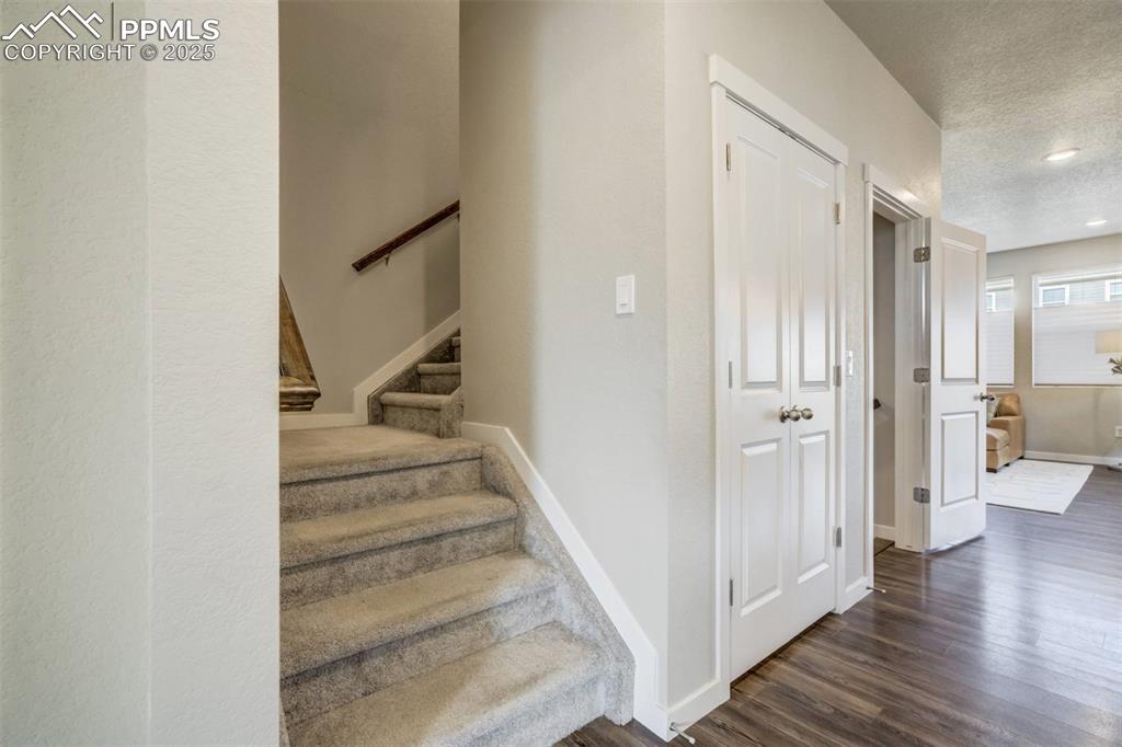 Image 19 of 44: Stairs to upper level and double doors to the second pantry. No shortage of