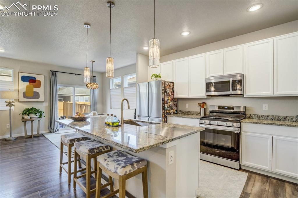 Image 2 of 44: Eat in kitchen on the island and easy access to open floor plan dining/livi
