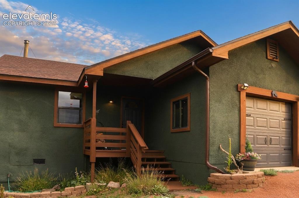 Image 10 of 46: Stucco exterior with wood trim accents