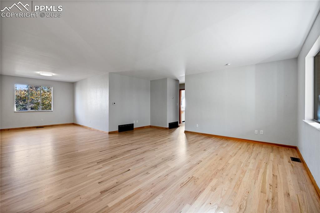 Image 5 of 50: Freshly refinished original hardwoods on the main level!