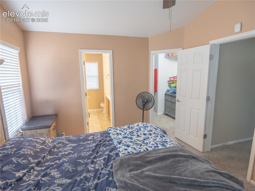 Image 12 of 13: Carpeted room with vaulted ceiling and neutral wall paint