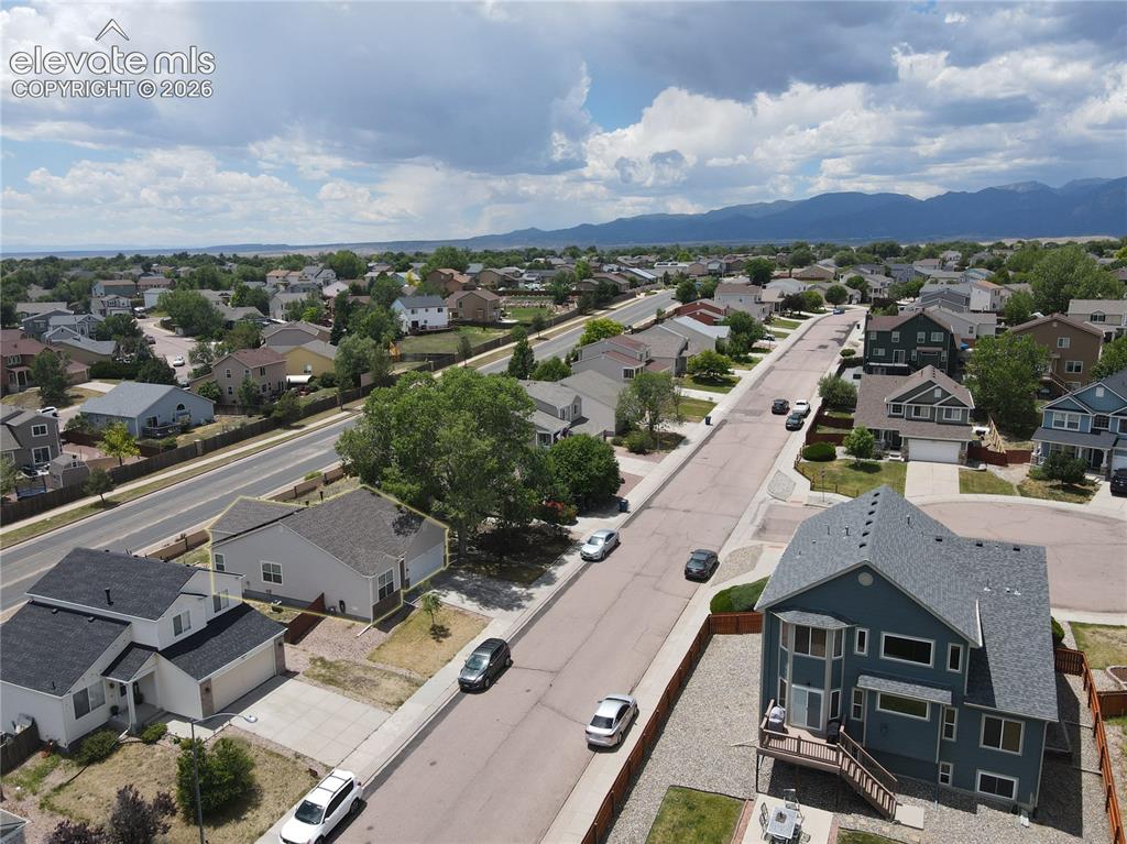 Image 13 of 17: Suburban street with residential properties featuring various architectural