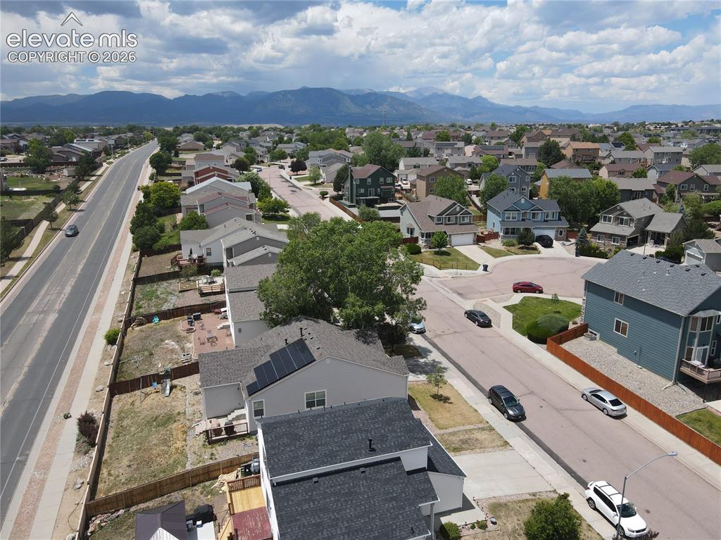 Image 15 of 17: Aerial perspective of a residential neighborhood with distant mountain rang