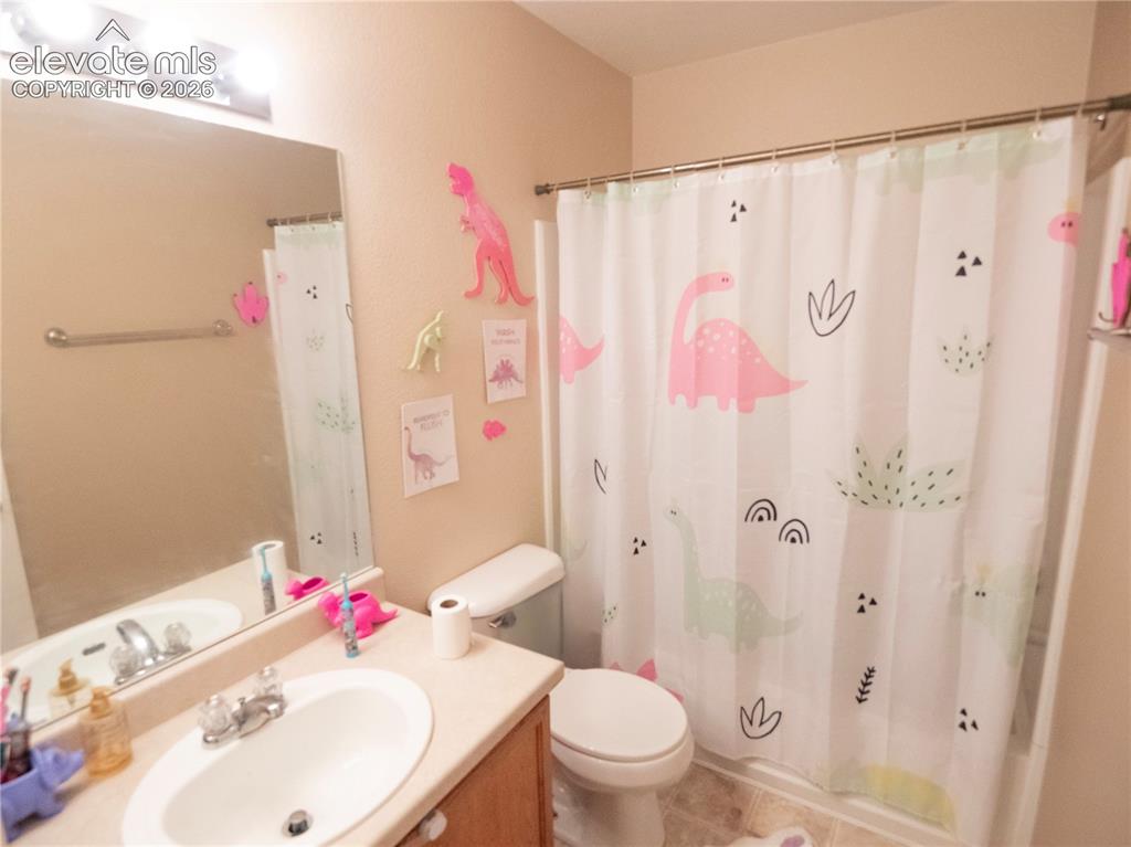 Image 6 of 13: Bathroom featuring a single vanity with an integrated sink, a large wall mi