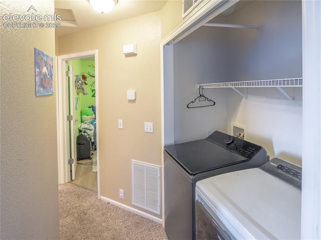 Image 8 of 13: Dedicated laundry closet featuring a wire shelf and clothing rod, positione