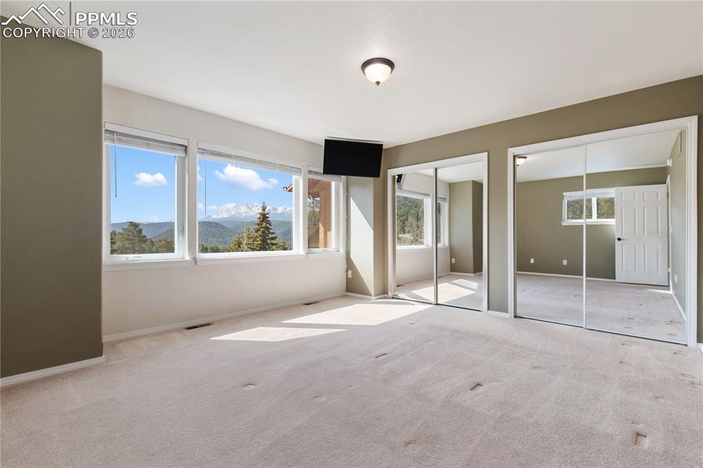 Image 15 of 29: Wall-to-wall carpeting and neutral-toned walls