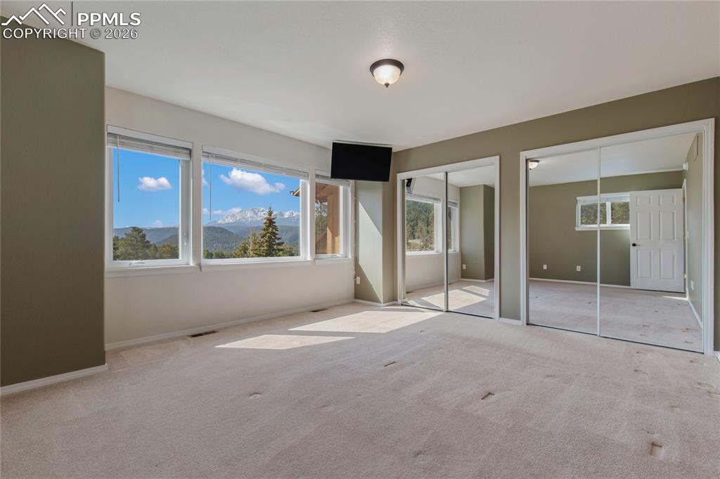 Image 16 of 29: Spacious interior room featuring multiple windows, offering expansive mount