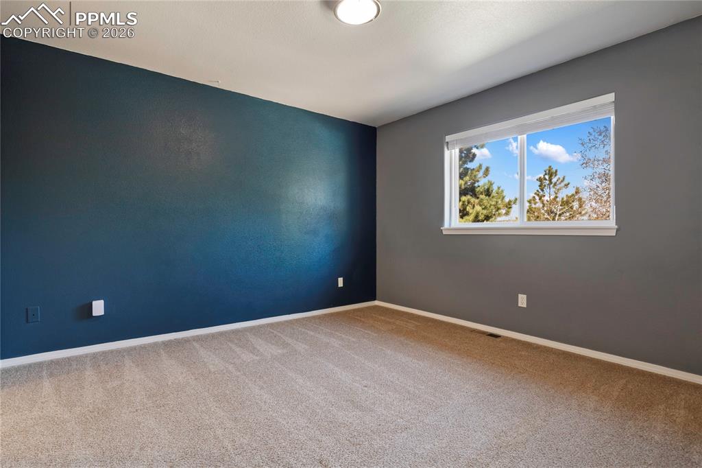 Image 23 of 29: Room featuring a window with exterior tree scenery, recessed ceiling light,