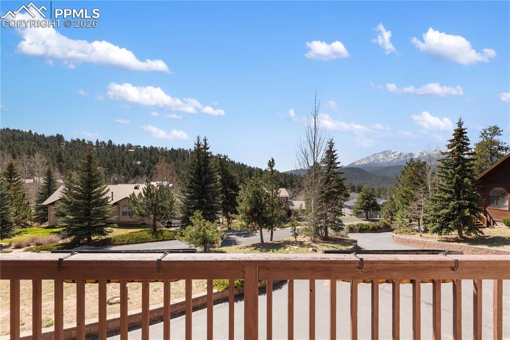 Image 28 of 29: Wood railing providing a frame to the mountainous backdrop