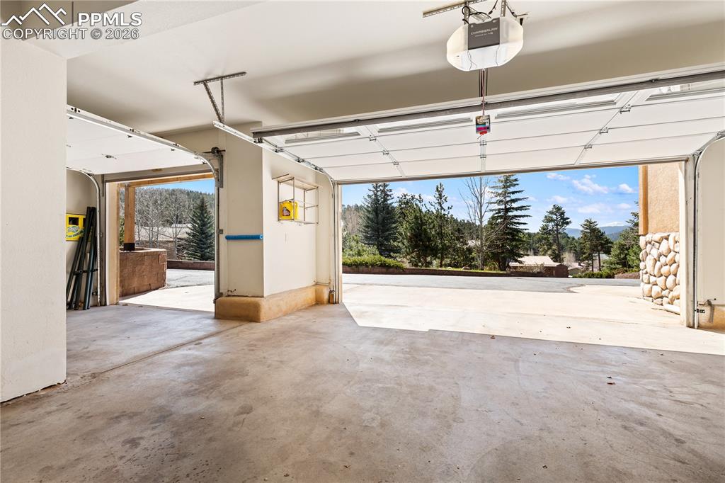 Image 29 of 29: Spacious three
-car garage with concrete flooring, automatic garage door o