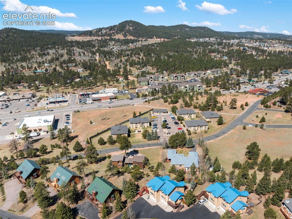 Image 31 of 33: Expansive aerial perspective showcasing a residential community nestled wit