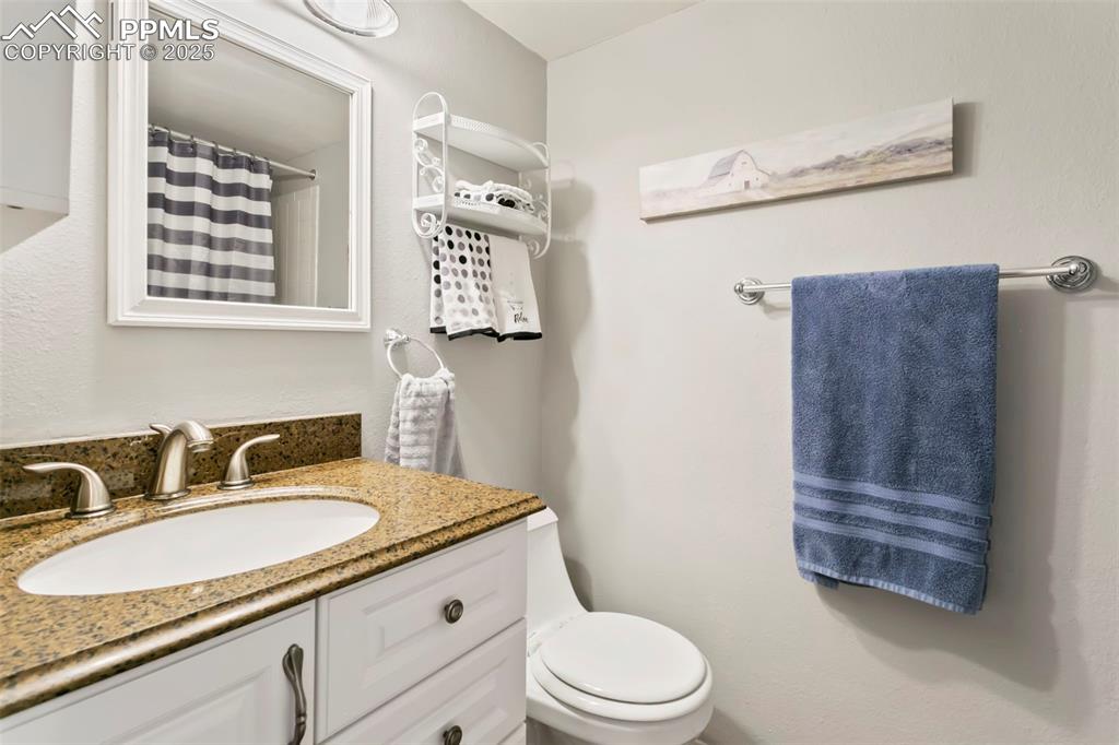 Image 12 of 17: Bathroom featuring vanity and a shower with curtain