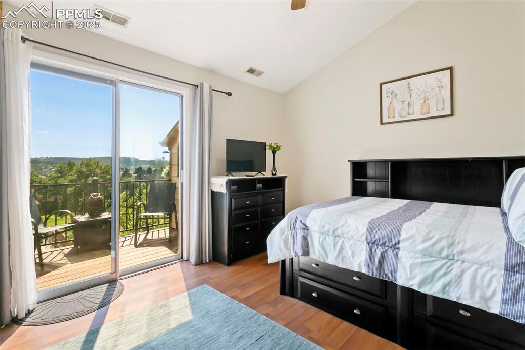 Image 13 of 17: Primary bedroom with vaulted ceiling and skylight