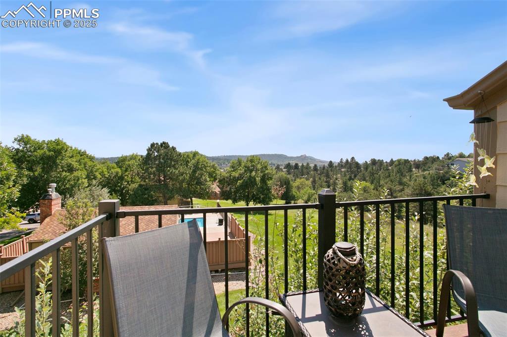 Image 16 of 17: Balcony with a mountain and pool view
