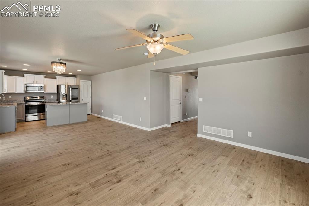 Image 10 of 35: Continue through the main level to find a bright and open living room, a sp