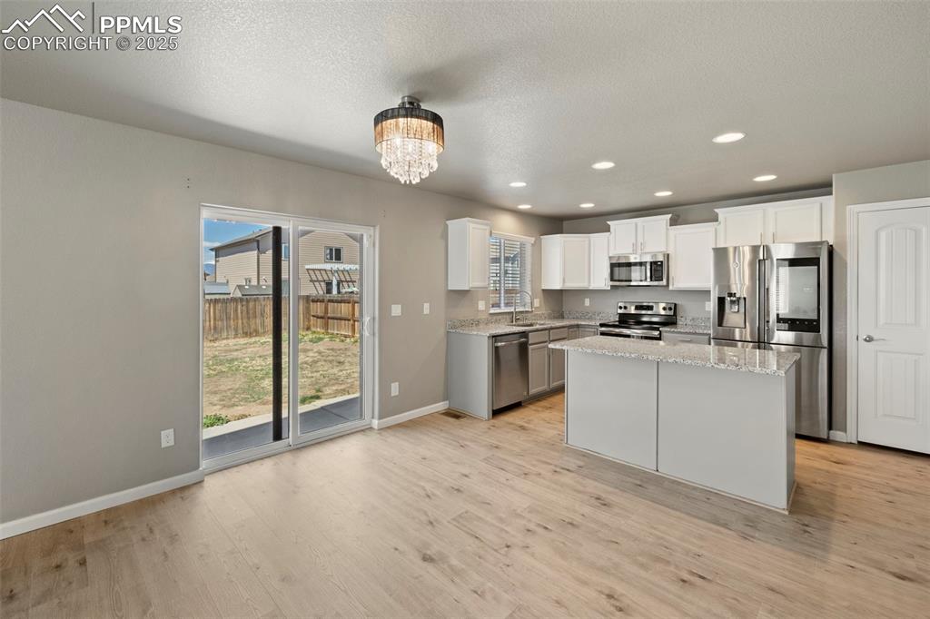 Image 12 of 35: well-appointed kitchen featuring granite countertops, a spacious center isl