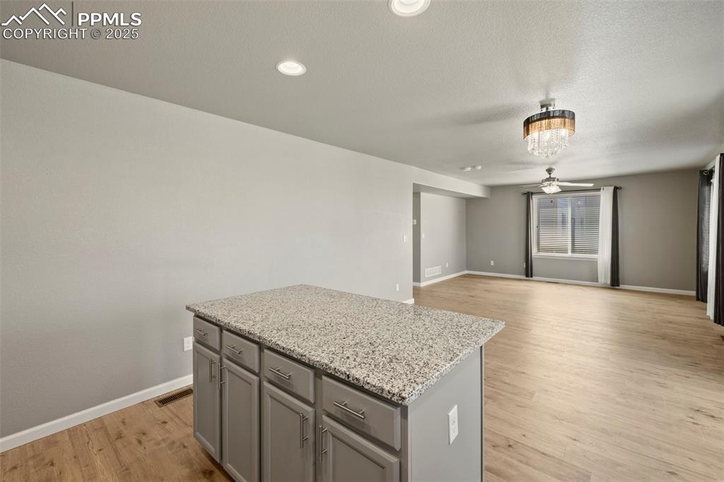 Image 16 of 35: well-appointed kitchen featuring granite countertops, a spacious center isl