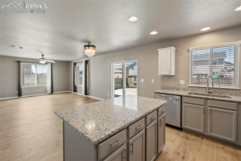 Image 17 of 35: well-appointed kitchen featuring granite countertops, a spacious center isl