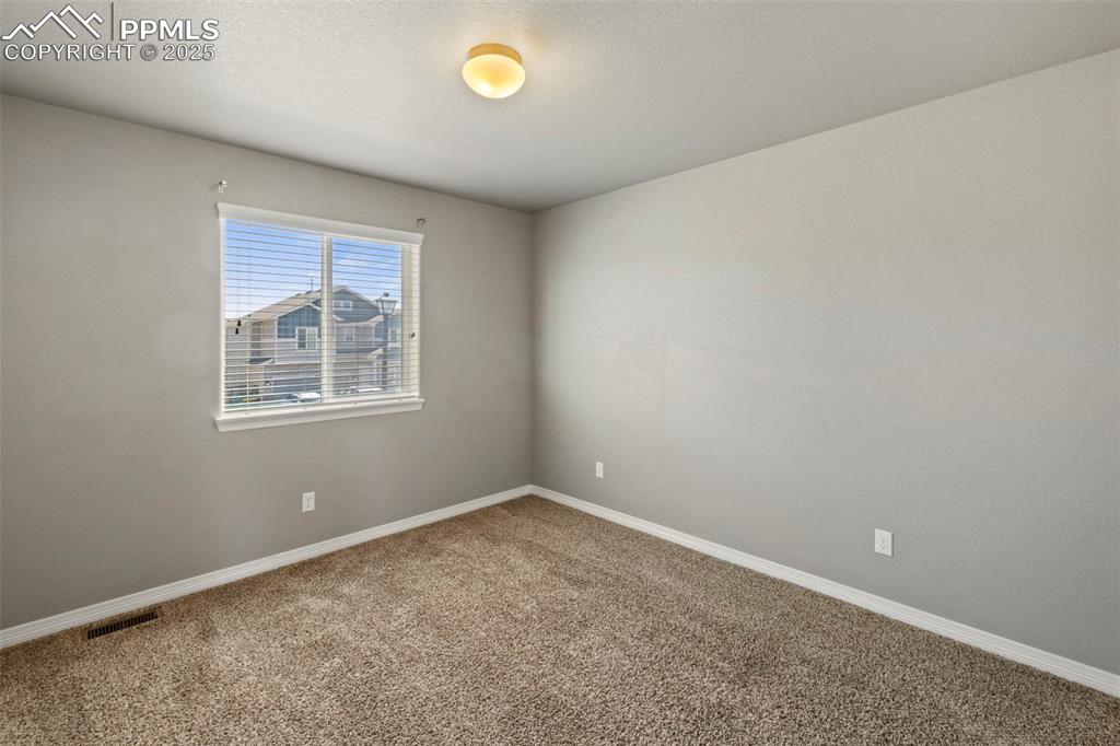 Image 24 of 35: Three additional bedrooms—two with carpet and one with a walk-in closet—sha