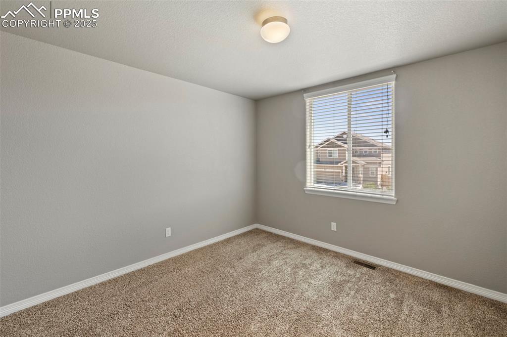 Image 27 of 35: Three additional bedrooms—two with carpet and one with a walk-in closet—sha