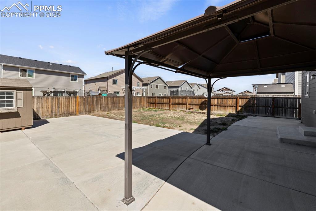 Image 31 of 35: Step outside to enjoy the large concrete wrap-around patio that extends aro