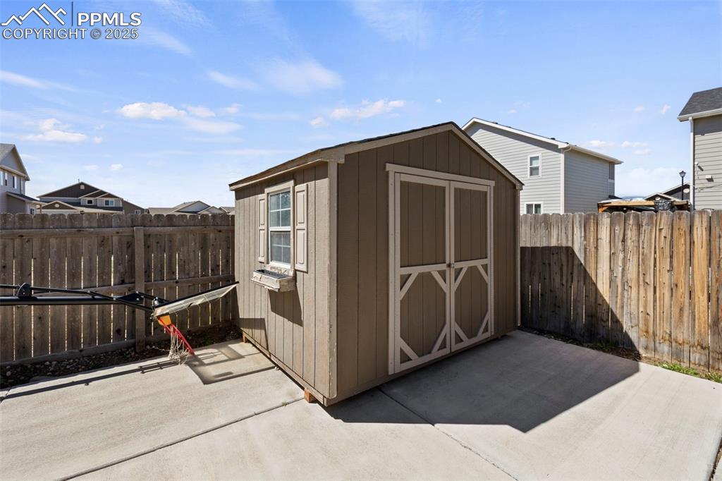 Image 32 of 35: Large storage shed in the backyard for storage
