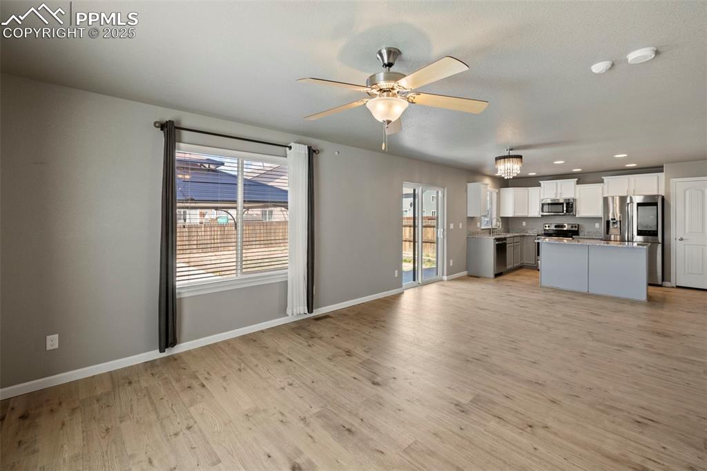 Image 9 of 35: Continue through the main level to find a bright and open living room, a sp
