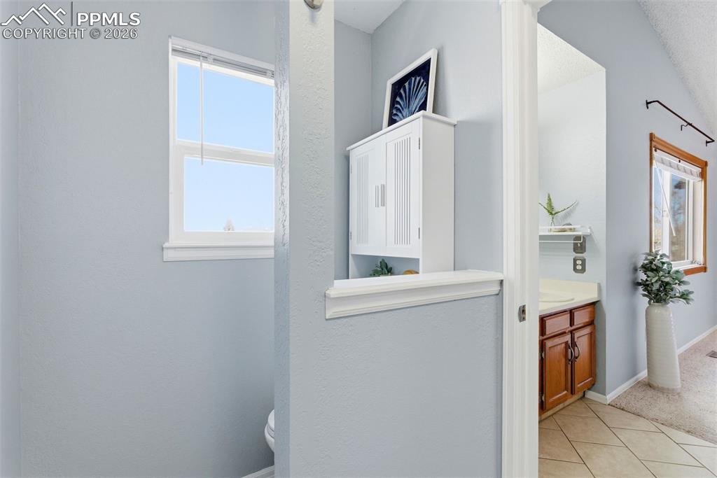 Image 20 of 45: Bathroom featuring vanity, light tile patterned floors, and light colored c