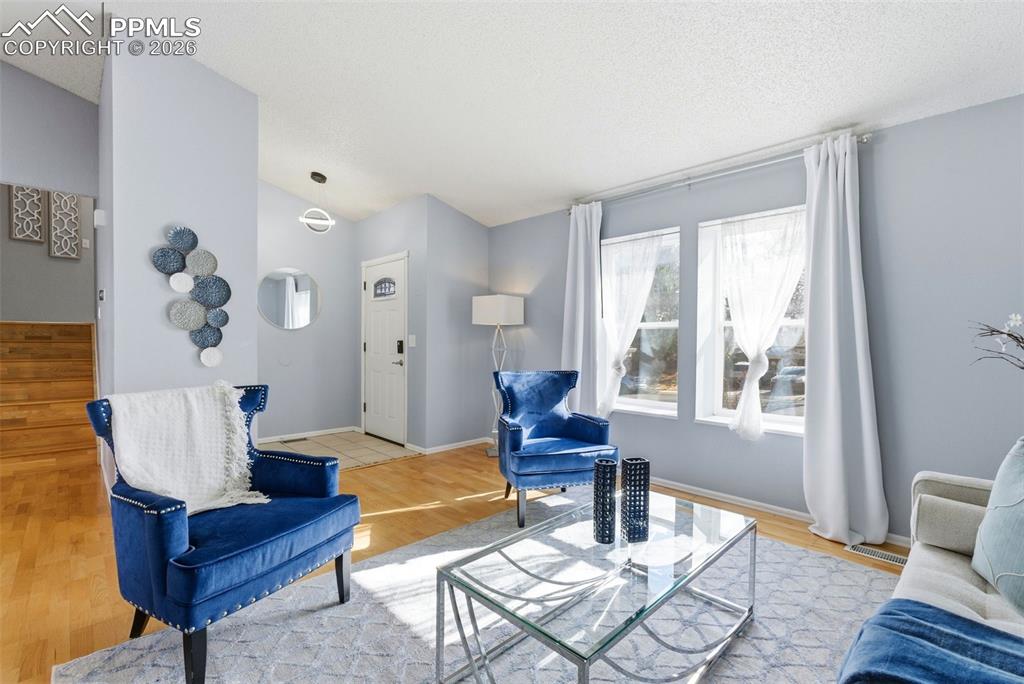 Image 3 of 45: Living area with light wood-style floors and baseboards